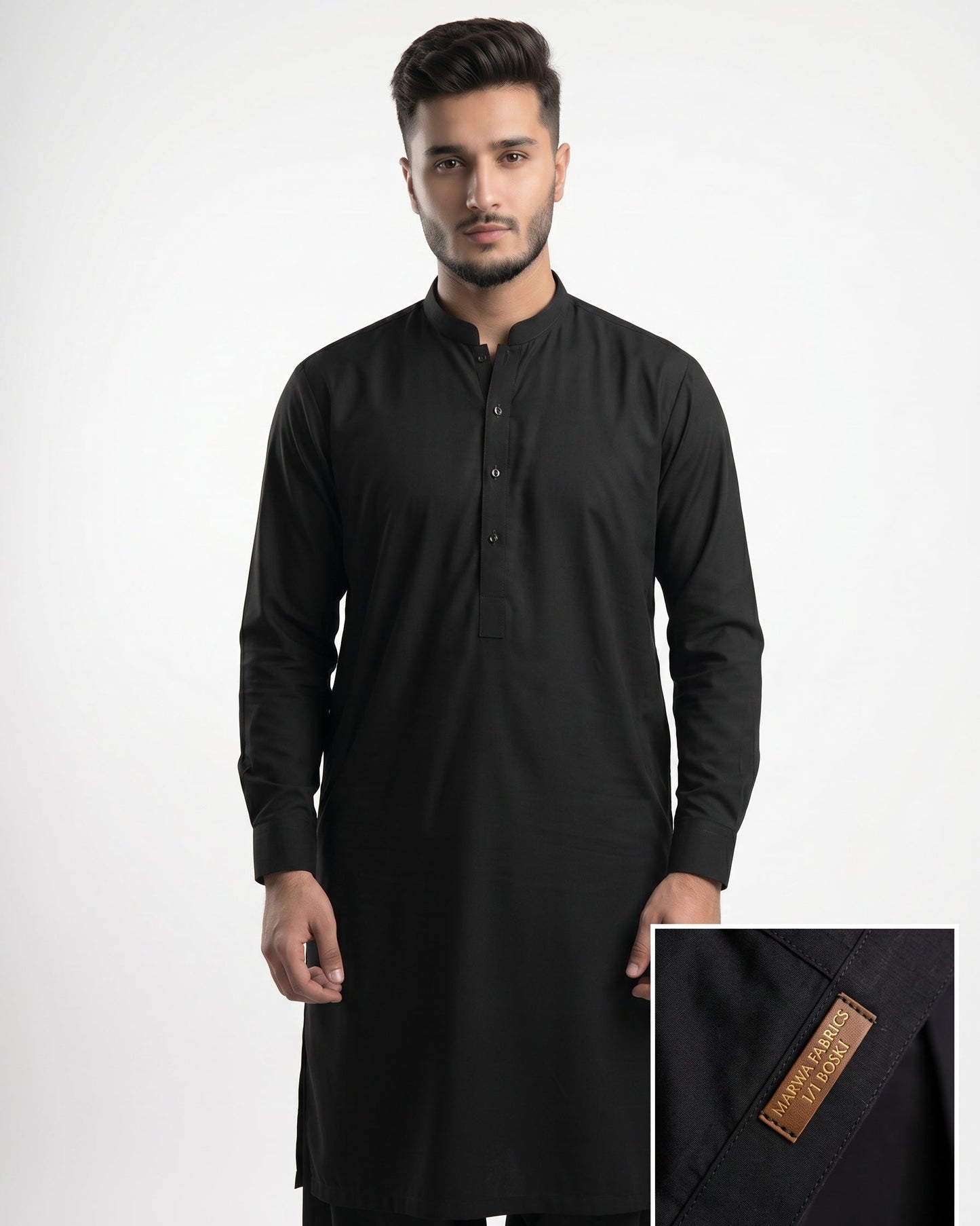 Man wearing a black kurta with a close-up of the brand label on a white background