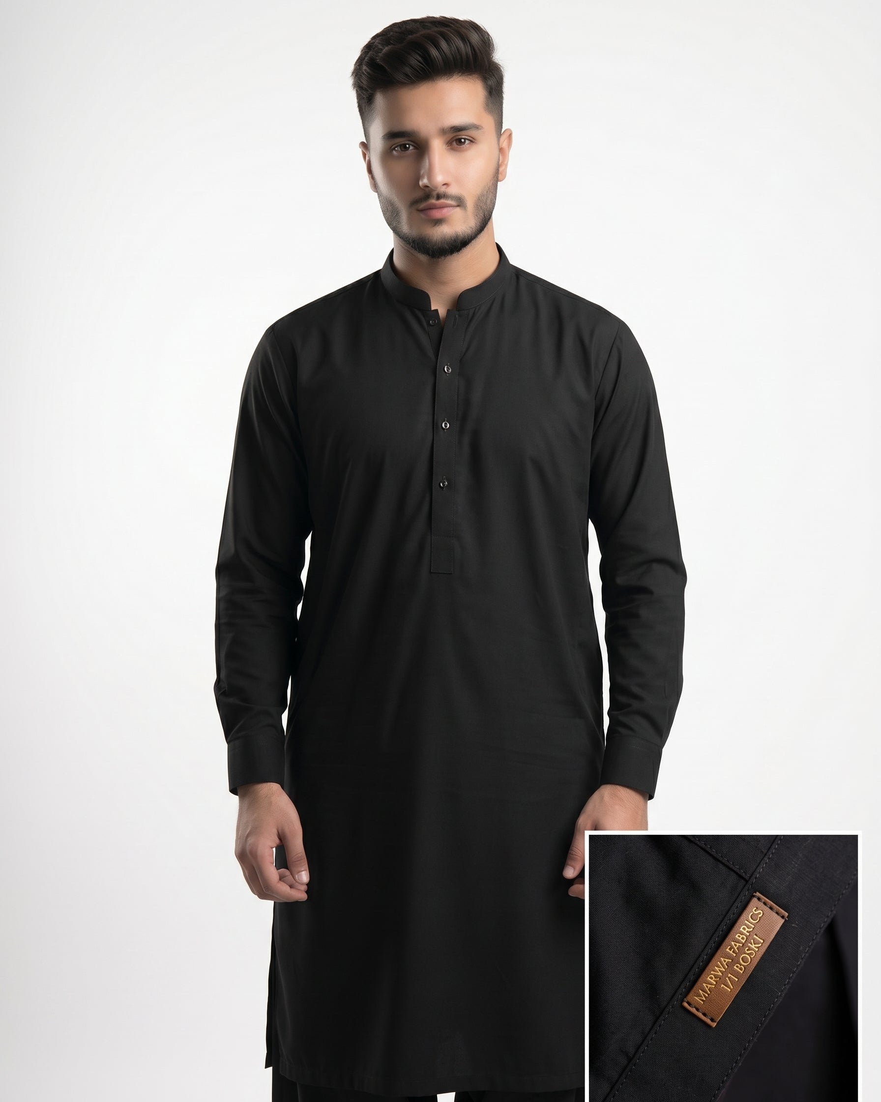 Man wearing a black kurta with a close-up of the brand label on a white background