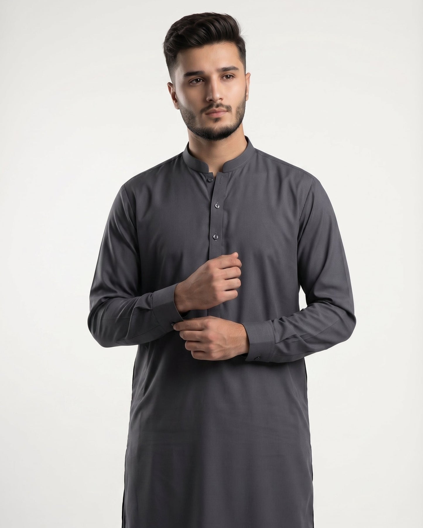 Man wearing a gray kurta with black pants on a white background