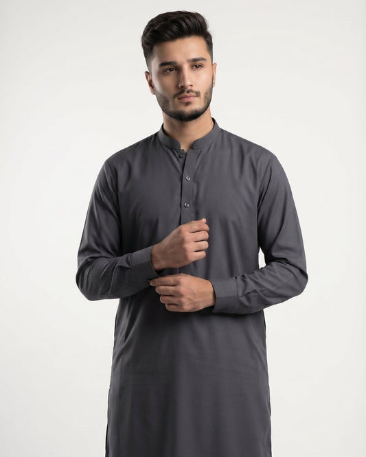 Man wearing a gray kurta with black pants on a white background