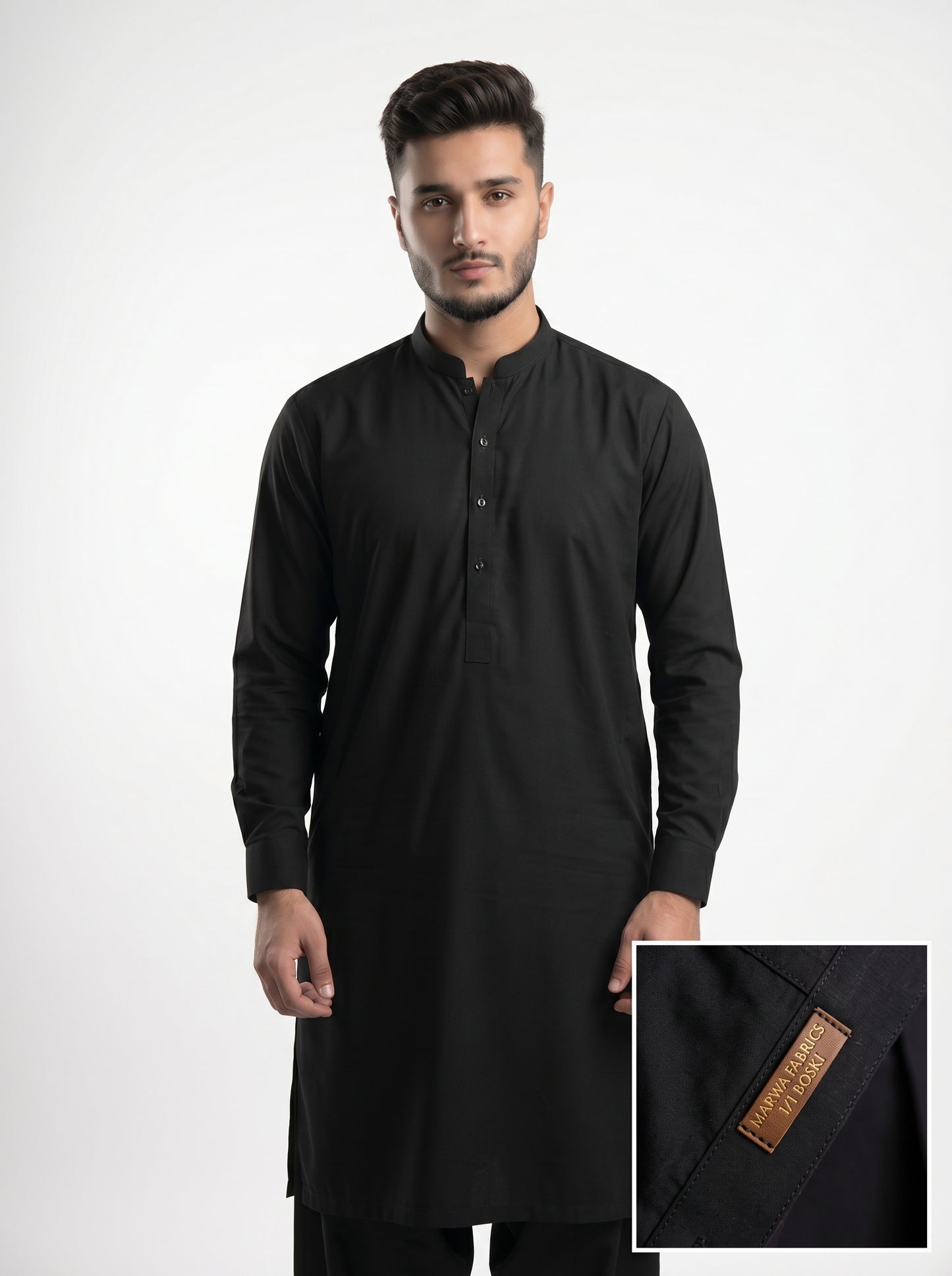 Man wearing a black kurta with a close-up of the brand label on a white background