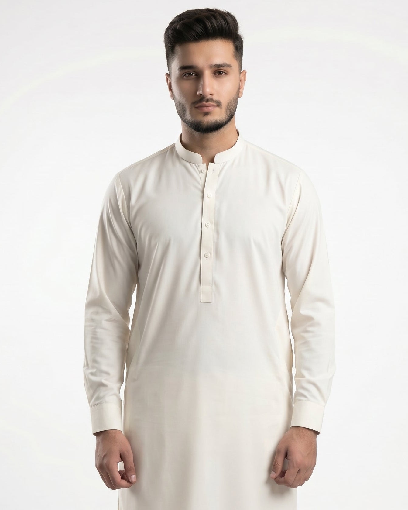 Man wearing a cream kurta with white pants on a white background
